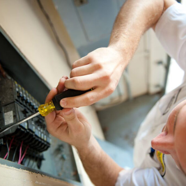 A Mister Sparky Electrician Tulsa technician fixes an electrical main panel in Tulsa, OK.