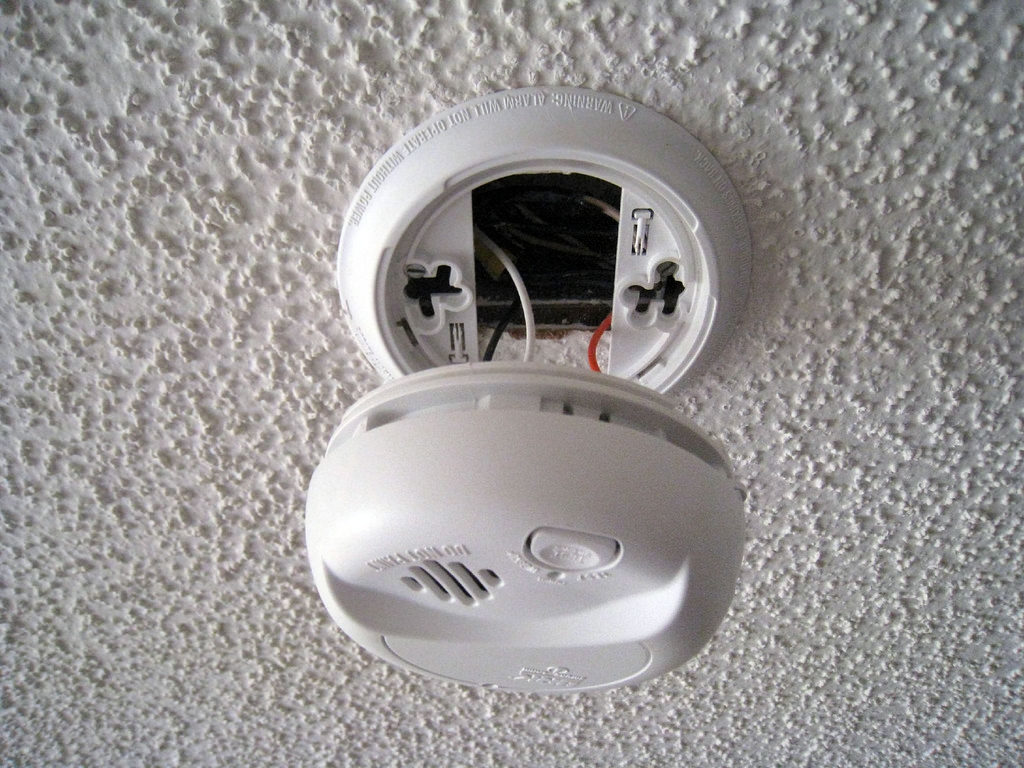 A smoke detector is being replaced during National Fire Safety Month.